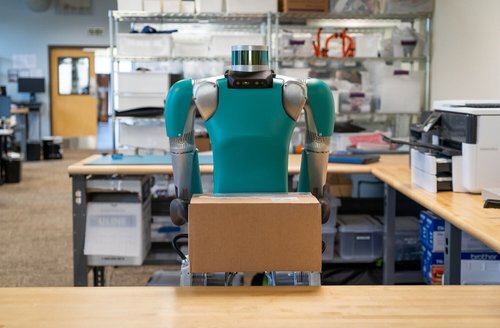 a robot carrying a box in a warehouse